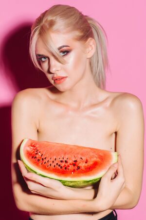 portrait happy young woman is holding slice of watermelon. Taste of watermelon. Summer. Fruits.の写真素材