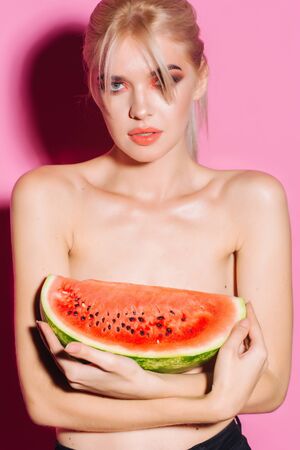 portrait happy young woman is holding slice of watermelon. Taste of watermelon. Summer. Fruits.の写真素材