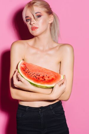 portrait happy young woman is holding slice of watermelon. Taste of watermelon. Summer. Fruits.の写真素材