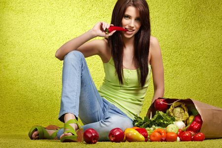 Portrait of a girl holding in hands full of different fruits and vegetables
の写真素材