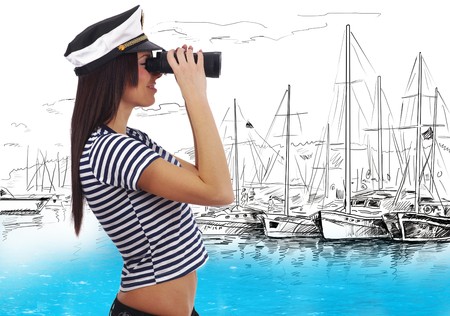 Close-up portrait of a woman as a sea captain holding binocularの写真素材