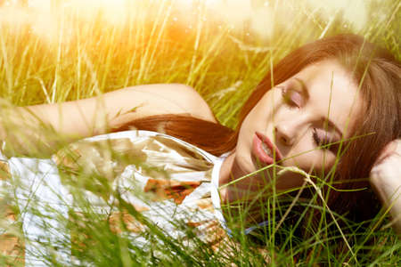 Portrait of the young beautiful smiling woman outdoors の写真素材