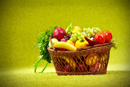  basket full of fresh produce  green backgroundの写真素材