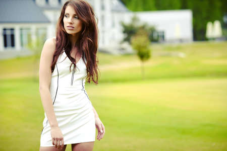 Happy young woman posing in front of her residence の写真素材