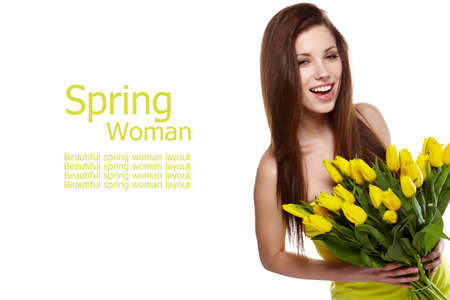 Happy woman with yellow tulips isolated on white background の写真素材