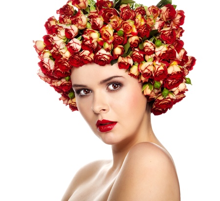 Portrait of young beautiful woman with roses in hair, on white background の写真素材