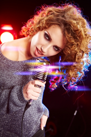 Beautiful brunette woman singing の写真素材