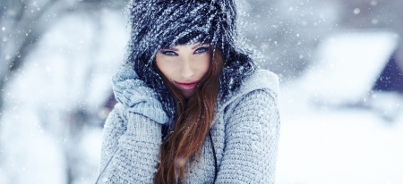 Girl playing with snow in park の写真素材