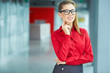 Portrait of happy smiling young businesswoman in office の写真素材