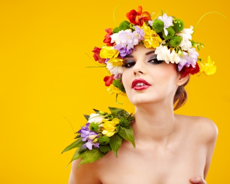 Woman with hairstyle and flower  Isolated on yellowの写真素材