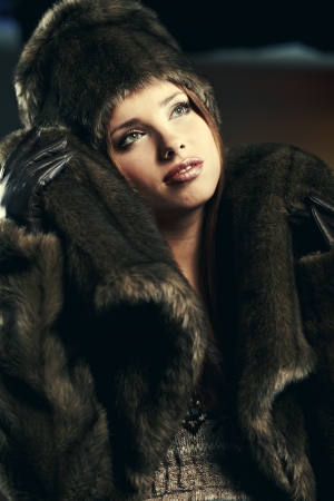Fashion portrait of young pretty woman with fur の写真素材