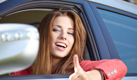 Smiling young pretty woman in the car 