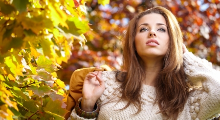 Young woman with autumn leaves in hand の写真素材