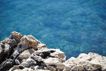 Rocks , sea and blue water backgroundの写真素材