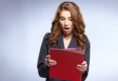 picture of a young attractive businesswoman with foldersの写真素材