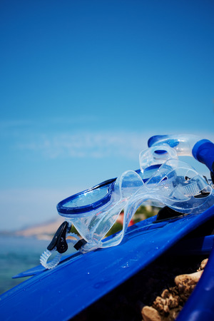 Mask and flippers on the beach の写真素材