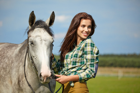 Woman with a white horse  outdoorの写真素材