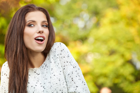 Beautiful autumn woman in golden park の写真素材
