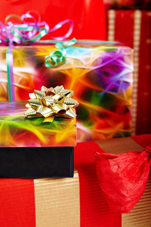 A pile of Christmas gifts in colorful wrapping with ribbons.の写真素材