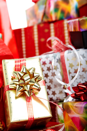 A pile of Christmas gifts in colorful wrapping with ribbons.の写真素材