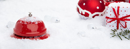 Red bell on snowの写真素材
