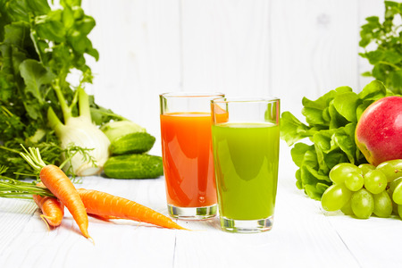 carrot juice on white wood tableの写真素材