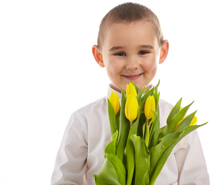 smiling little boy giving tulips