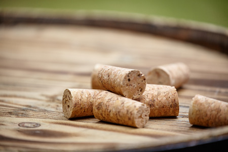 Many wine corks on wood barrel