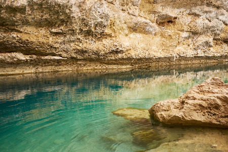 Sinkhole with emerald green water at Hawiyat Najm Park, Omanの写真素材