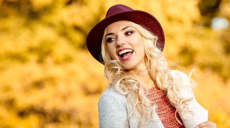 Beautiful elegant woman standing in  autumn parkの写真素材