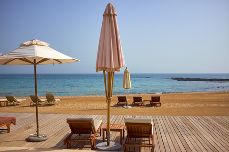 empty sun loungers on the beach