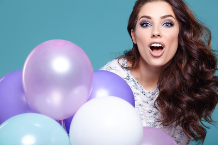 Happy young woman with colorful latex balloons,の写真素材
