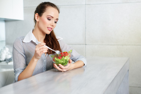 Beautiful Young Woman Eating Vegetable Salad .Dieting concept.Healthy Foodの写真素材