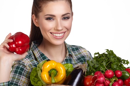 beautiful young woman with vegetables and fruits in shopping bagの写真素材