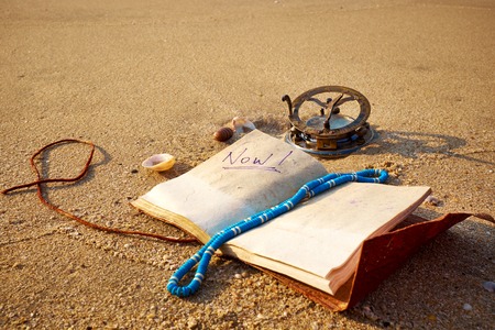 panorama of tropical beach with old vintage sundial and notebookの写真素材