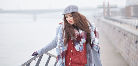 fashion woman walking outdoor against an city river landscapeの写真素材