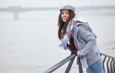 fashion woman walking outdoor against an city river landscapeの写真素材