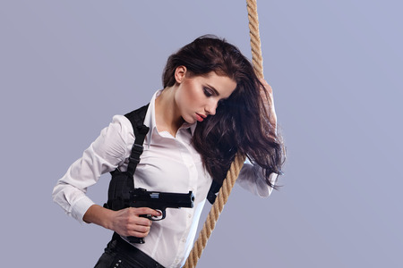Young  sexy Woman holding Handgun in handの写真素材