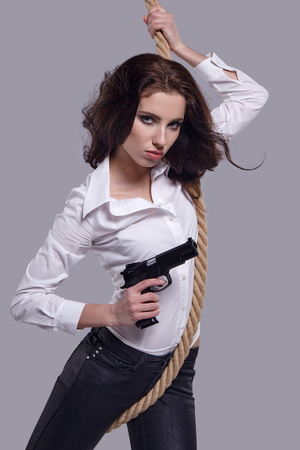 Young  sexy Woman holding Handgun in handの写真素材