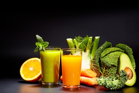 Glasses with fresh vegetable juices isolated on black. Detox diet.の写真素材