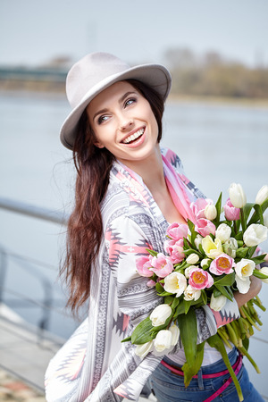 Woman with tulips. Beautiful woman with flowers.の写真素材