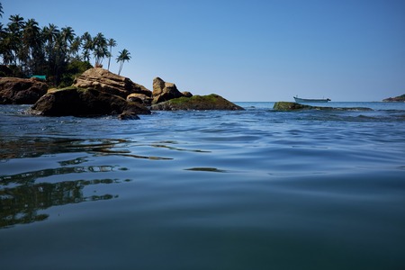 landscape of tropical beach with rocks, South Goa, Indiaの写真素材