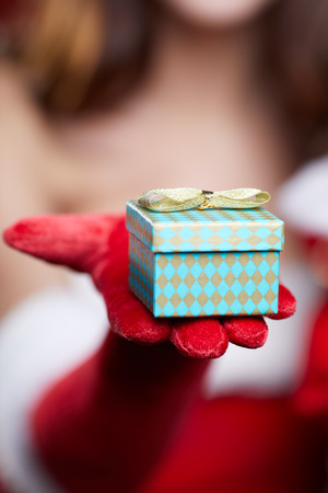 Small gift on model hand. Christmas concept. Macro.の写真素材