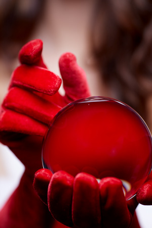 Christmas background with a shiny glass ball on model hands. Christmas concept.の写真素材