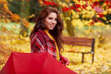 Beautiful woman in autumn park .の写真素材