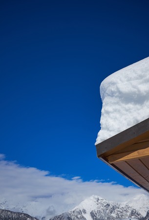 Snow drift on roof after two days of snowfalls .