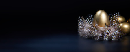 easter golden eggs on black backgroundの写真素材