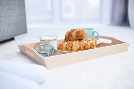 breakfast in bed with coffee and croissantsの写真素材