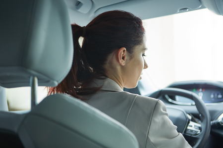 Business woman driving her new  carの写真素材