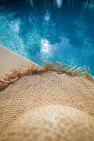hat by a swimming pool. Backgroud conceptの写真素材